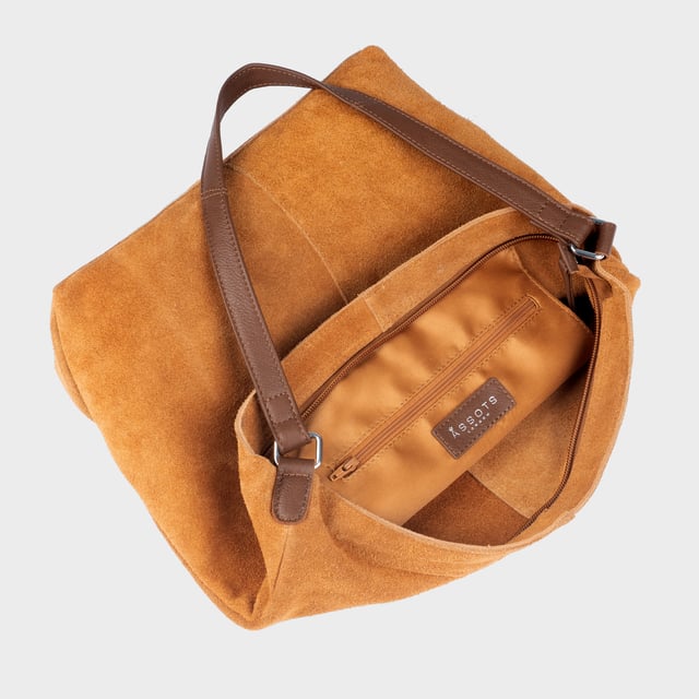 Size: 34cm x 35cm x 8cm. The ‘Tina’ designer slouchy tote bag is a refined statement of luxury and everyday versatility. Crafted from premium suede leather, it features a secure zip closure and a roomy, unlined interior, showcasing the authentic beauty of genuine leather. Thoughtfully designed for the modern professional, this timeless tote transitions effortlessly from business meetings to casual outings and evening events, offering a perfect combination of sophistication and practicality. Crafted from fine-napped suede leather for that slouchy look. Smooth zipper opens to a roomy unlined interior, offering both style and functionality. Extra-long full grain leather shoulder handles ensure a secure, slip-free fit, even over an overcoat. Internal secured zip pocket keeps your mobile phone, car keys, and house keys safe and accessible. Composition: Body - 100% Genuine Leather, Hardware -  Shiny Silver, Lining - Unlined.