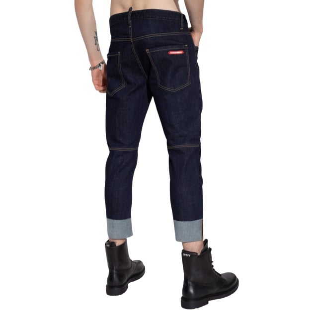 Elevate your wardrobe with the Dsquared2 Sailor Jean in dark blue denim, crafted from a premium blend of 99% cotton and 1% elastane for exceptional comfort and durability. These men's jeans offer a modern fit that moves with you, combining classic sailor-inspired style with contemporary tailoring. The rich navy blue color adds versatility, making them perfect for both casual outings and smart-casual occasions. Designed to provide lasting wear and a flattering silhouette, these jeans are a must-have for those who value quality and style in their everyday attire