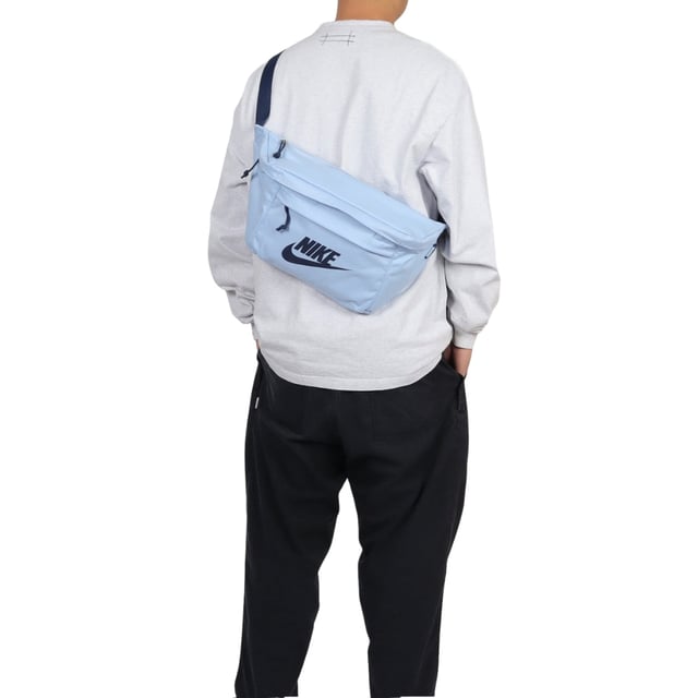 Nike Light Blue Crossover Bag The Nike Light Blue Crossover Bag combines style and practicality in one sleek design. Crafted from durable 100% polyester, this bag features a spacious 10-litre main compartment with a secure zip fastening, perfect for keeping your essentials safe on the go. The front zip pocket offers easy access to smaller items, while the large Nike Swoosh logo adds a bold, sporty touch. An adjustable strap with a buckle clip ensures a comfortable, customizable fit for all-day wear. Ideal for daily use, this lightweight crossover bag keeps your belongings organized and within reach wherever you head
