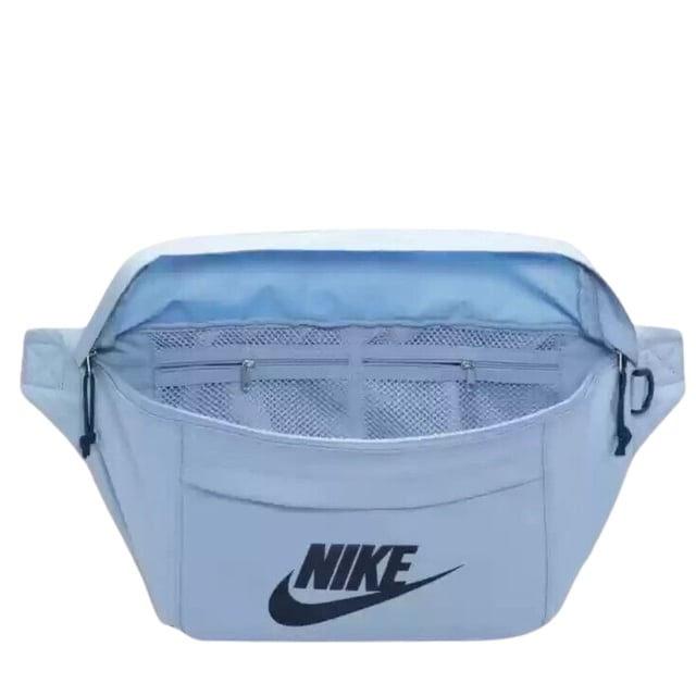 Nike Light Blue Crossover Bag The Nike Light Blue Crossover Bag combines style and practicality in one sleek design. Crafted from durable 100% polyester, this bag features a spacious 10-litre main compartment with a secure zip fastening, perfect for keeping your essentials safe on the go. The front zip pocket offers easy access to smaller items, while the large Nike Swoosh logo adds a bold, sporty touch. An adjustable strap with a buckle clip ensures a comfortable, customizable fit for all-day wear. Ideal for daily use, this lightweight crossover bag keeps your belongings organized and within reach wherever you head