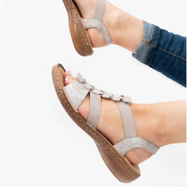 These synthetic women's sandals feature a cross-strap design with a round toe and flat heel, offering comfort for casual wear. They are lightweight and easy to fasten