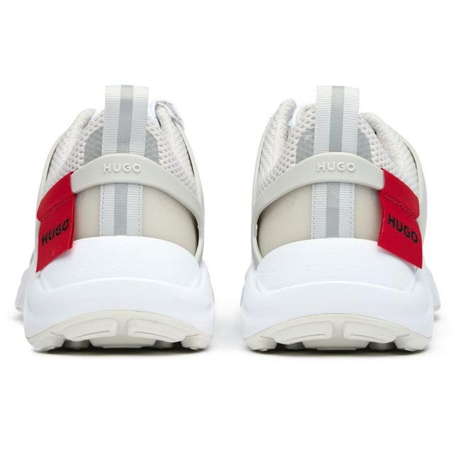 The Hugo Go 2 delivers sophisticated athletic style for the modern man. These white trainers blend performance-inspired design with premium materials, featuring a lightweight nylon upper that ensures breathability and comfort. With their sleek silhouette and rubber outsole providing reliable traction, these versatile HUGO sneakers transition effortlessly from casual outings to active weekends. A refined choice that balances contemporary aesthetics with practical functionality for your everyday wardrobe.
