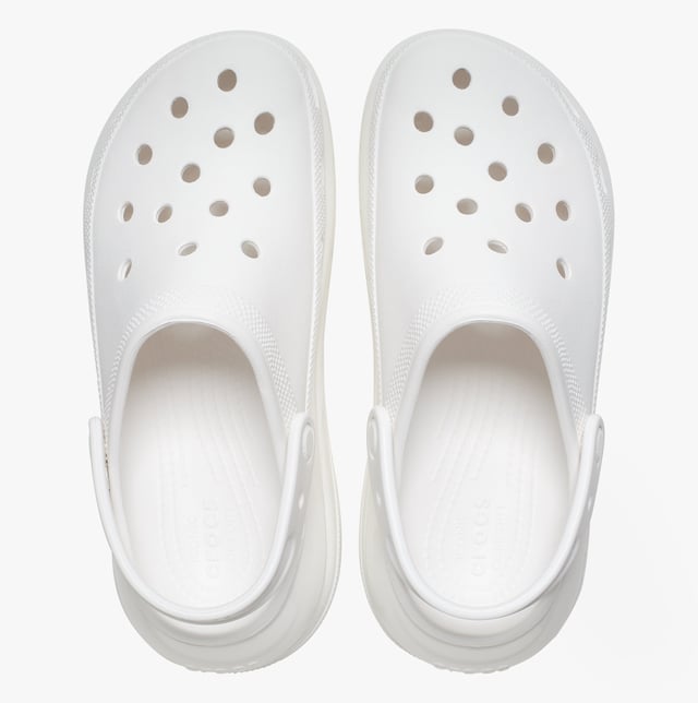 These women's slip-on clogs feature Croslite material for comfort and breathability, a platform heel, and a round toe, ideal for casual wear and all-day ease
