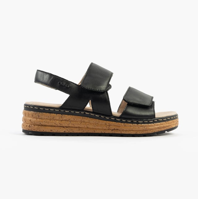 These open-toe women's sandals feature a leather upper, breathable lining, wedge heel, and extra-wide fit for comfort. Ideal for casual wear and easy to slip on with touch fasten closure