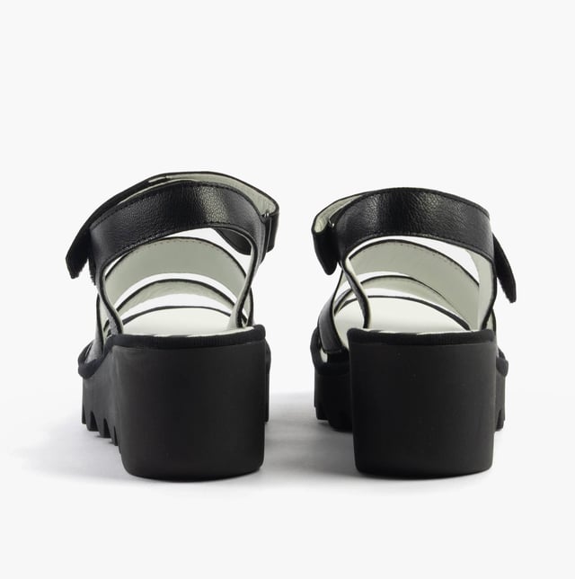 These open-toe wedge sandals feature a leather upper and lining with a rubber sole, offering comfort and breathability for casual wear