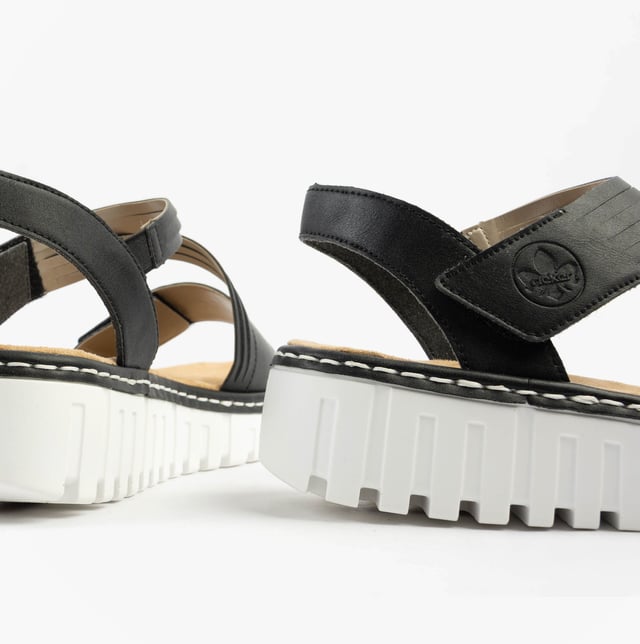 These women's open-toe wedge sandals feature a synthetic upper, breathable textile lining, and a RIRICON sole. Low heel height offers comfort for casual wear