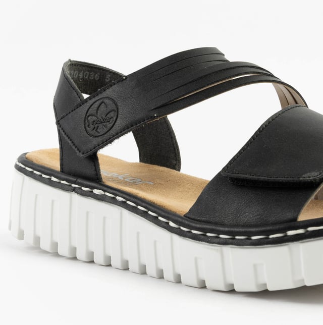 These women's open-toe wedge sandals feature a synthetic upper, breathable textile lining, and a RIRICON sole. Low heel height offers comfort for casual wear