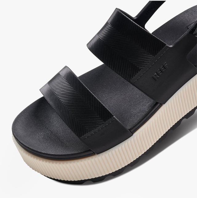 These open-toe women's sandals feature a synthetic upper, EVA lining and sole, a low platform heel, and a touch fasten closure, offering comfortable casual wear