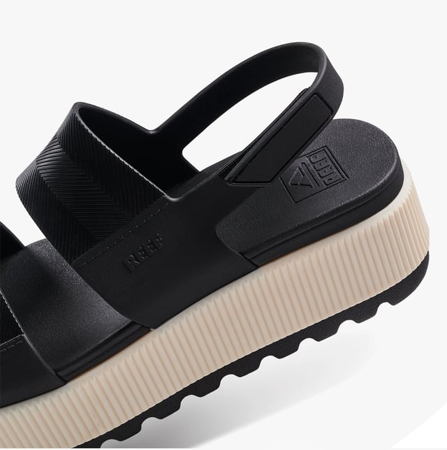 These open-toe women's sandals feature a synthetic upper, EVA lining and sole, a low platform heel, and a touch fasten closure, offering comfortable casual wear