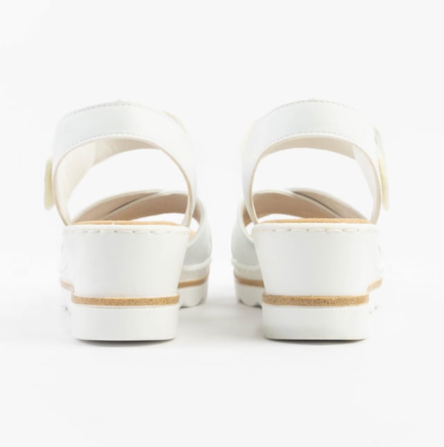 These women's wedge sandals feature a synthetic upper, breathable textile lining, and a PU sole for comfort. Ideal for casual wear with a relaxed fit and secure buckle closure