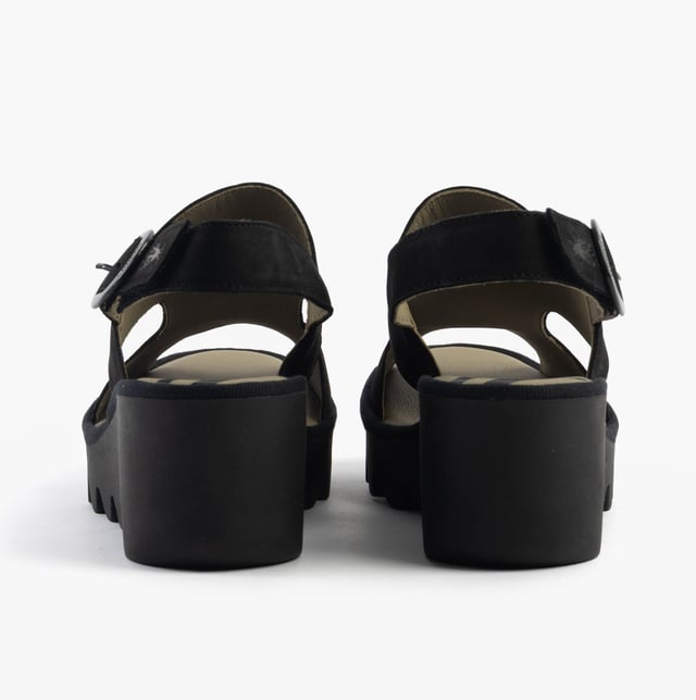 These open-toe wedge sandals feature a leather upper and lining with a TPR sole, offering comfort and breathability for casual wear