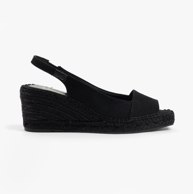 These women's slip-on sandals feature a textile upper and lining, rubber sole, low wedge heel, and open toe design, offering comfort and vegan-friendly style for casual wear