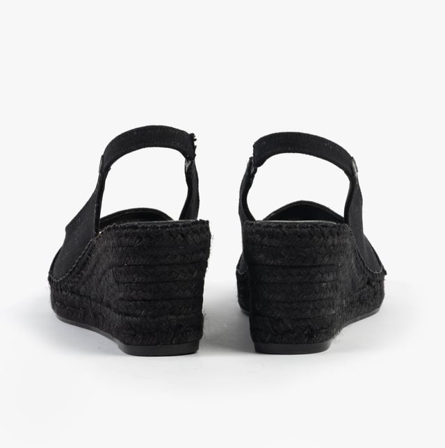 These women's slip-on sandals feature a textile upper and lining, rubber sole, low wedge heel, and open toe design, offering comfort and vegan-friendly style for casual wear