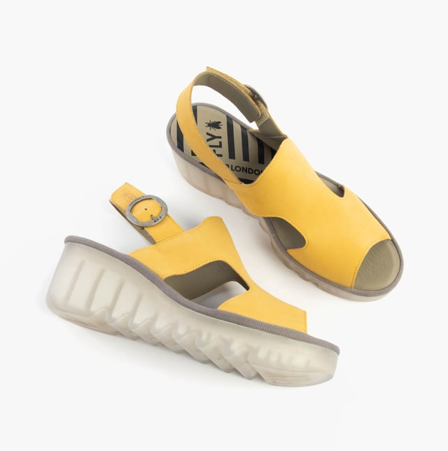 These open-toe wedge sandals feature a leather upper and lining with a breathable design, a TPR sole, and buckle closure, offering comfort for casual wear