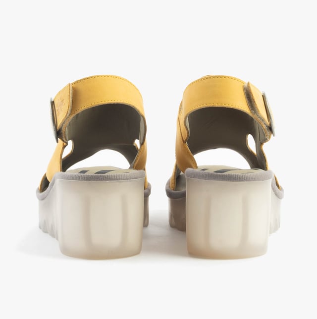 These open-toe wedge sandals feature a leather upper and lining with a breathable design, a TPR sole, and buckle closure, offering comfort for casual wear