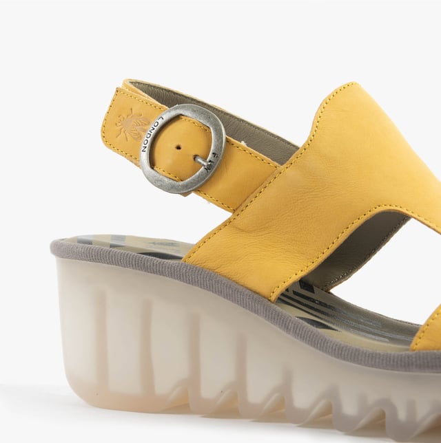 These open-toe wedge sandals feature a leather upper and lining with a breathable design, a TPR sole, and buckle closure, offering comfort for casual wear