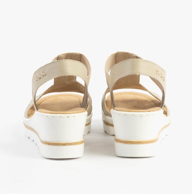 These women's wedge sandals feature a synthetic upper, breathable textile lining, and a slip-on design. Lightweight and comfortable, ideal for casual warm-weather wear