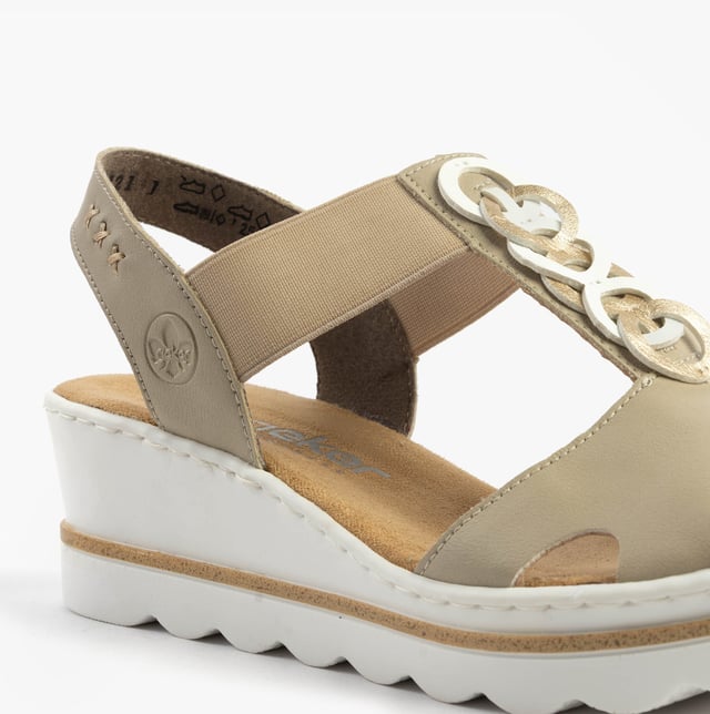 These women's wedge sandals feature a synthetic upper, breathable textile lining, and a slip-on design. Lightweight and comfortable, ideal for casual warm-weather wear