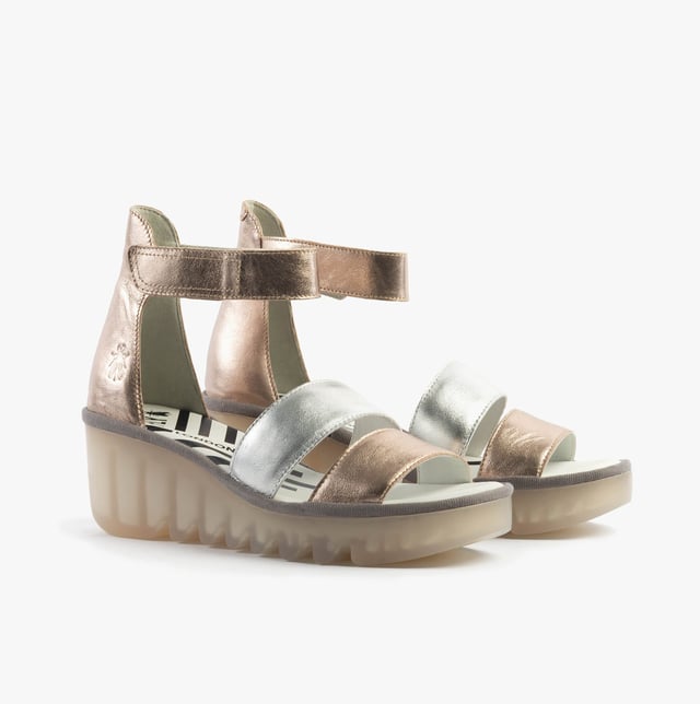 These open-toe wedge sandals feature a leather upper and lining with a TPR sole, offering breathable comfort. Ideal for casual wear and easy to slip on with touch fasten closure