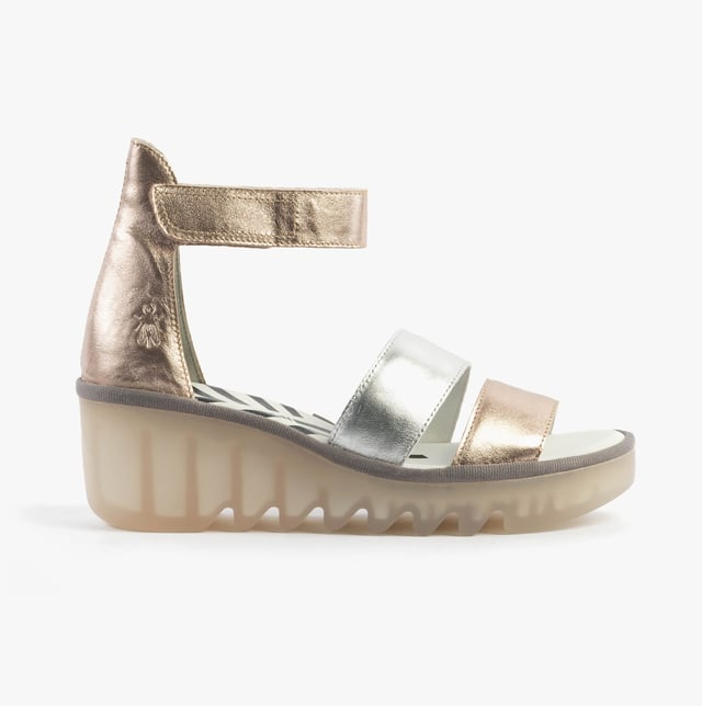 These open-toe wedge sandals feature a leather upper and lining with a TPR sole, offering breathable comfort. Ideal for casual wear and easy to slip on with touch fasten closure