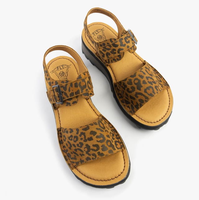 These open-toe wedge sandals feature a leather upper and lining with a TPR sole, offering comfort and breathability for casual wear