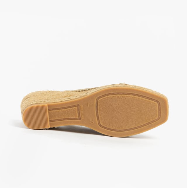 These slip-on wedge sandals feature a textile upper and lining with a rubber sole, offering comfort and vegan-friendly design, perfect for casual wear