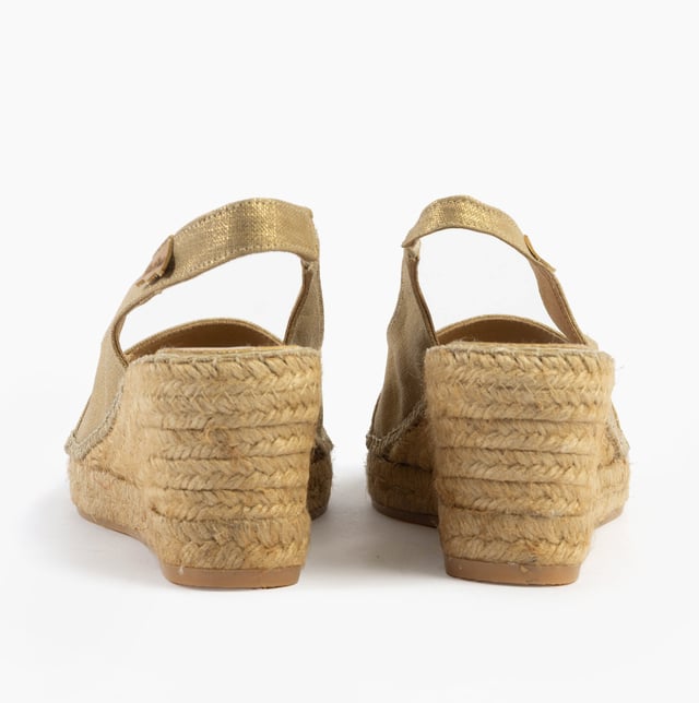 These slip-on wedge sandals feature a textile upper and lining with a rubber sole, offering comfort and vegan-friendly design, perfect for casual wear
