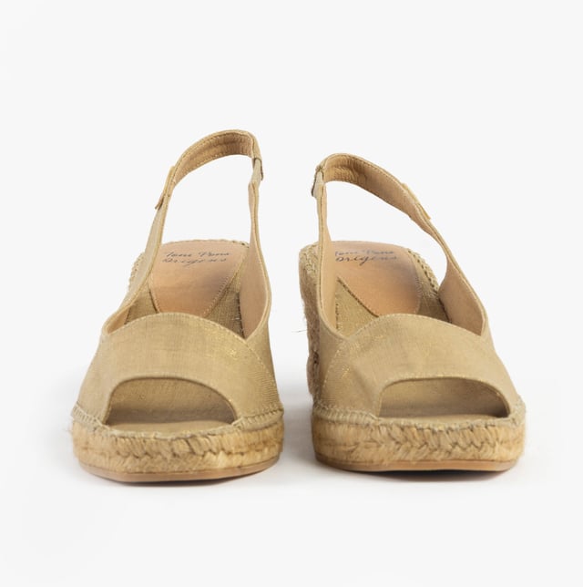 These slip-on wedge sandals feature a textile upper and lining with a rubber sole, offering comfort and vegan-friendly design, perfect for casual wear