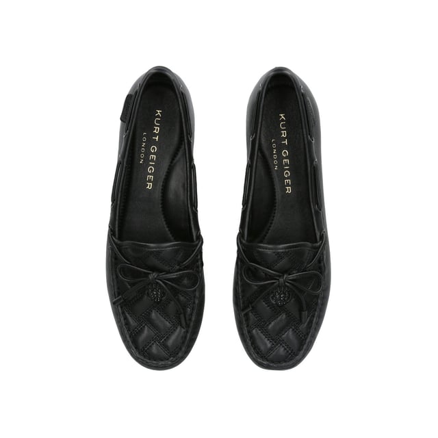 The Eagle Moccasin from Kurt Geiger is crafted from a black leather in an all-drench design. The toe features an overstitched quilt and a black eagle head.