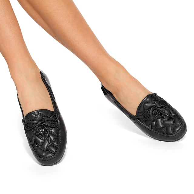 The Eagle Moccasin from Kurt Geiger is crafted from a black leather in an all-drench design. The toe features an overstitched quilt and a black eagle head.
