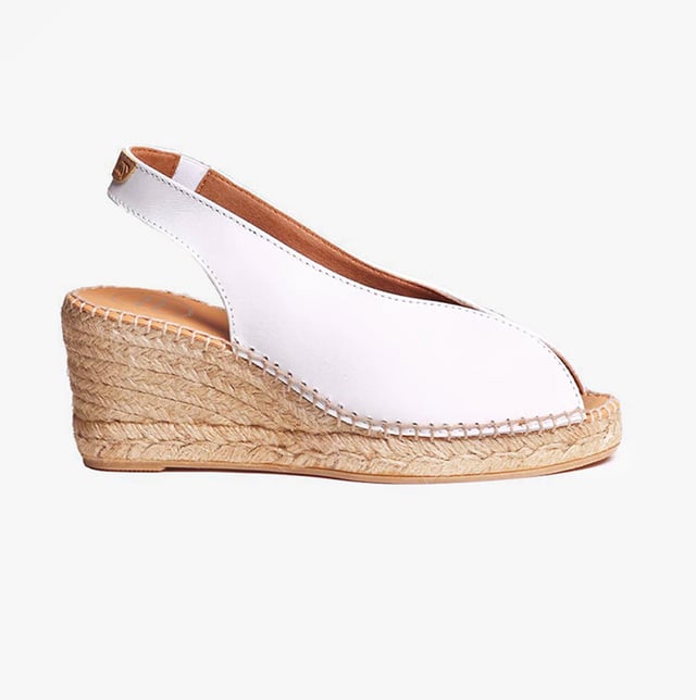 These women's espadrille sandals feature a leather upper and lining with a synthetic sole, a wedge heel, and slip-on design, offering comfort and breathability for casual wear