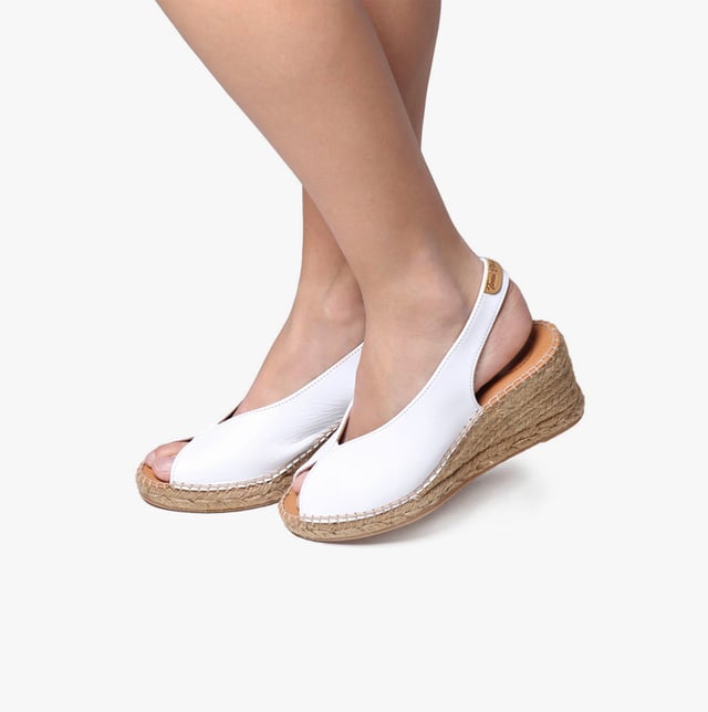 These women's espadrille sandals feature a leather upper and lining with a synthetic sole, a wedge heel, and slip-on design, offering comfort and breathability for casual wear
