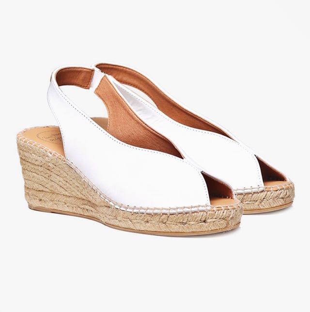 These women's espadrille sandals feature a leather upper and lining with a synthetic sole, a wedge heel, and slip-on design, offering comfort and breathability for casual wear