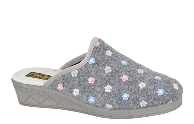 Step into effortless elegance with the Sleepers Josephine Wedge Womens Mule Slipper. Crafted from soft grey floral embroidered textile, this stylish slip-on mule features a subtle wedge heel for a touch of lift and sophistication. The cosy textile lining ensures all-day comfort, while the durable vulcanised rubber sole provides reliable grip and support. Perfect for indoor wear with a fashionable edge, the Josephine slipper blends classic design with practical comfort.
 
 - Floral embroidered textile upper
 - Slip on mule design
 - Cosy textile lining provide 
 - Vulcanised rubber sole
 - Subtle wedge heel
 - Sleepers branding
