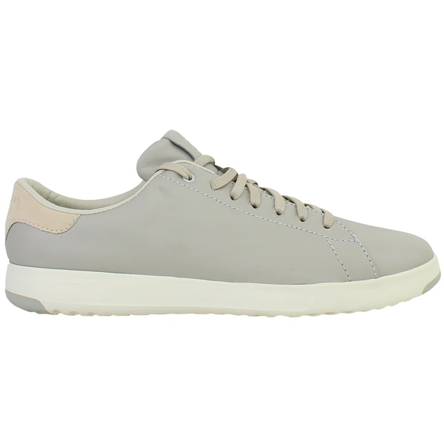 Minimalist, lightweight, and designed for modern movement, the Cole Haan GrandPrø Women’s Tennis Shoes in Grey combine sleek court-inspired aesthetics with innovative comfort. Whether you're navigating the city or enjoying weekend downtime, these trainers offer a versatile blend of style and performance.
Key Features
Lightweight EVA Midsole

Provides responsive cushioning and shock absorption without adding bulk—perfect for all-day wear.

Classic Tennis Sneaker Silhouette

Low-top profile with subtle retro detailing that works seamlessly with casual or smart-casual outfits.

Cushioned Ortholite® Footbed

Adds underfoot softness and moisture-wicking properties to enhance long-term comfort.

Durable Rubber Outsole with Traction Pods

Ensures flexible grip and stability on a variety of surfaces—from pavement to polished floors.

Lace-Up Closure

Allows for an adjustable, secure fit with a timeless look.

Padded Collar and Tongue

Boosts ankle comfort while providing subtle structure and support.

Soft Grey Colourway

Neutral, understated tone that complements everything from denim and joggers to dresses and skirts.

Whether you're dressing up your casual wardrobe or seeking reliable all-day comfort, the Cole Haan GrandPrø Women’s Grey Tennis Shoes deliver premium craftsmanship and sporty elegance in one essential pair.