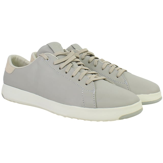 Minimalist, lightweight, and designed for modern movement, the Cole Haan GrandPrø Women’s Tennis Shoes in Grey combine sleek court-inspired aesthetics with innovative comfort. Whether you're navigating the city or enjoying weekend downtime, these trainers offer a versatile blend of style and performance.
Key Features
Lightweight EVA Midsole

Provides responsive cushioning and shock absorption without adding bulk—perfect for all-day wear.

Classic Tennis Sneaker Silhouette

Low-top profile with subtle retro detailing that works seamlessly with casual or smart-casual outfits.

Cushioned Ortholite® Footbed

Adds underfoot softness and moisture-wicking properties to enhance long-term comfort.

Durable Rubber Outsole with Traction Pods

Ensures flexible grip and stability on a variety of surfaces—from pavement to polished floors.

Lace-Up Closure

Allows for an adjustable, secure fit with a timeless look.

Padded Collar and Tongue

Boosts ankle comfort while providing subtle structure and support.

Soft Grey Colourway

Neutral, understated tone that complements everything from denim and joggers to dresses and skirts.

Whether you're dressing up your casual wardrobe or seeking reliable all-day comfort, the Cole Haan GrandPrø Women’s Grey Tennis Shoes deliver premium craftsmanship and sporty elegance in one essential pair.