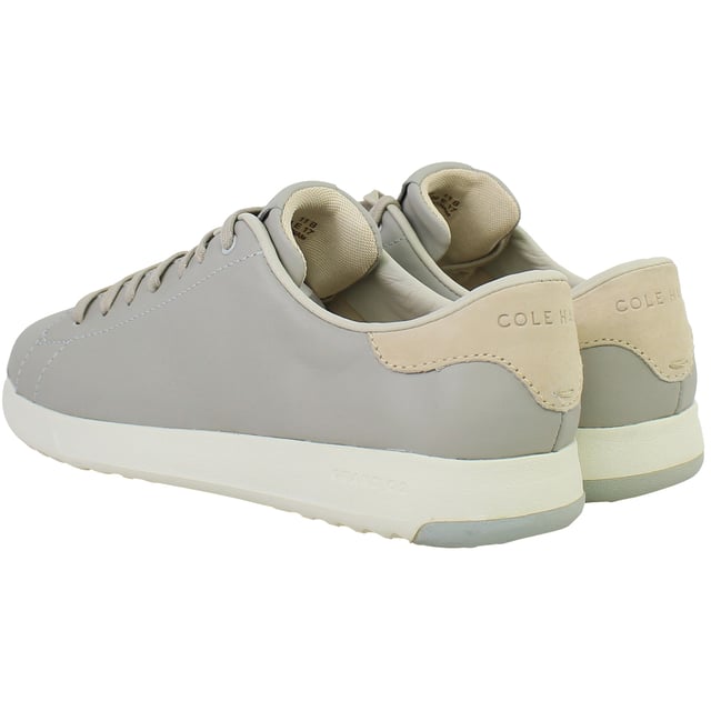 Minimalist, lightweight, and designed for modern movement, the Cole Haan GrandPrø Women’s Tennis Shoes in Grey combine sleek court-inspired aesthetics with innovative comfort. Whether you're navigating the city or enjoying weekend downtime, these trainers offer a versatile blend of style and performance.
Key Features
Lightweight EVA Midsole

Provides responsive cushioning and shock absorption without adding bulk—perfect for all-day wear.

Classic Tennis Sneaker Silhouette

Low-top profile with subtle retro detailing that works seamlessly with casual or smart-casual outfits.

Cushioned Ortholite® Footbed

Adds underfoot softness and moisture-wicking properties to enhance long-term comfort.

Durable Rubber Outsole with Traction Pods

Ensures flexible grip and stability on a variety of surfaces—from pavement to polished floors.

Lace-Up Closure

Allows for an adjustable, secure fit with a timeless look.

Padded Collar and Tongue

Boosts ankle comfort while providing subtle structure and support.

Soft Grey Colourway

Neutral, understated tone that complements everything from denim and joggers to dresses and skirts.

Whether you're dressing up your casual wardrobe or seeking reliable all-day comfort, the Cole Haan GrandPrø Women’s Grey Tennis Shoes deliver premium craftsmanship and sporty elegance in one essential pair.