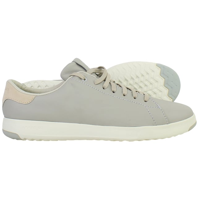 Minimalist, lightweight, and designed for modern movement, the Cole Haan GrandPrø Women’s Tennis Shoes in Grey combine sleek court-inspired aesthetics with innovative comfort. Whether you're navigating the city or enjoying weekend downtime, these trainers offer a versatile blend of style and performance.
Key Features
Lightweight EVA Midsole

Provides responsive cushioning and shock absorption without adding bulk—perfect for all-day wear.

Classic Tennis Sneaker Silhouette

Low-top profile with subtle retro detailing that works seamlessly with casual or smart-casual outfits.

Cushioned Ortholite® Footbed

Adds underfoot softness and moisture-wicking properties to enhance long-term comfort.

Durable Rubber Outsole with Traction Pods

Ensures flexible grip and stability on a variety of surfaces—from pavement to polished floors.

Lace-Up Closure

Allows for an adjustable, secure fit with a timeless look.

Padded Collar and Tongue

Boosts ankle comfort while providing subtle structure and support.

Soft Grey Colourway

Neutral, understated tone that complements everything from denim and joggers to dresses and skirts.

Whether you're dressing up your casual wardrobe or seeking reliable all-day comfort, the Cole Haan GrandPrø Women’s Grey Tennis Shoes deliver premium craftsmanship and sporty elegance in one essential pair.
