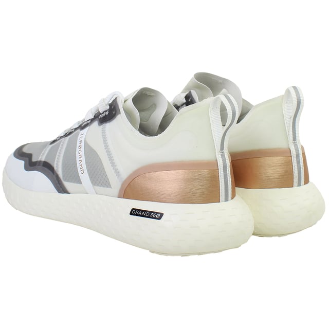 Engineered for performance and styled for versatility, the Cole Haan ZERØGRAND Outpace Women’s Running Shoes in White deliver responsive comfort, lightweight agility, and a clean, modern silhouette. Whether you're racking up miles or heading into your day, these trainers are built to move with you—effortlessly and in style.
Key Features
Breathable Mesh Upper

Lightweight and flexible with enhanced airflow to keep feet cool and comfortable through workouts or daily wear.

ZERØGRAND Cushioned Midsole

Advanced EVA midsole absorbs shock and adds bounce with every step, offering a plush ride on the go.

Stabilizing Internal Heel Counter

Supports the rear foot for better alignment and reduced fatigue during long runs or walks.

Durable Rubber Traction Pods

Strategically placed outsole rubber ensures grip and durability without adding excess weight.

Padded Collar and Tongue

Adds ankle comfort and reduces pressure points for a secure, supported feel.

Lace-Up Closure

Classic lacing system for an adjustable and snug fit.

All-White Colourway

Clean and versatile—pairs effortlessly with activewear, athleisure, or street-style outfits.

From morning jogs to afternoon errands, the Cole Haan ZERØGRAND Outpace Women’s White Running Shoes combine athletic performance with everyday wearability—designed to help you go further, faster, and in flawless style.