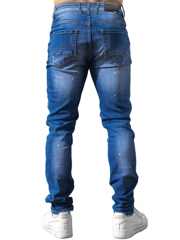 Enzo Milano | Mens Ripped Jeans Upgrade your denim game with the Enzo Milano slim fit Jeans for men, crafted for style and comfort. Featuring bold ripped and repaired detailing, these denim jeans deliver a rugged, contemporary look accentuated by unique paint splash accents. The tapered leg creates a modern silhouette, while premium stretch fabric ensures ease of movement and a perfect fit. A concealed zip fly fastening adds a clean finish, complemented by a classic 5-pocket design for everyday practicality. Finished with the signature Enzo Milano PU branded label at the back, these denim trousers embody high-quality craftsmanship and distinctive urban flair.