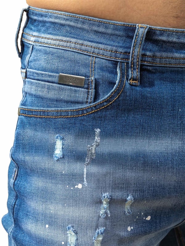 Enzo Milano | Mens Ripped Jeans Upgrade your denim game with the Enzo Milano slim fit Jeans for men, crafted for style and comfort. Featuring bold ripped and repaired detailing, these denim jeans deliver a rugged, contemporary look accentuated by unique paint splash accents. The tapered leg creates a modern silhouette, while premium stretch fabric ensures ease of movement and a perfect fit. A concealed zip fly fastening adds a clean finish, complemented by a classic 5-pocket design for everyday practicality. Finished with the signature Enzo Milano PU branded label at the back, these denim trousers embody high-quality craftsmanship and distinctive urban flair.
