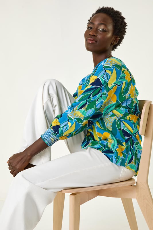 Leaf Print 3/4 Sleeve Top from Roman. Channel tropical vibes with this leaf print top, perfect for the Spring Summer season. The flattering square neckline and 3/4 length sleeves make this tee a must-have in your wardrobe. Crafted from a comfortable woven fabric, it showcases an all-over tropical leaf print for a fresh and stylish look. Dress it up with a denim jacket and jeggings for the ultimate casual outfit!