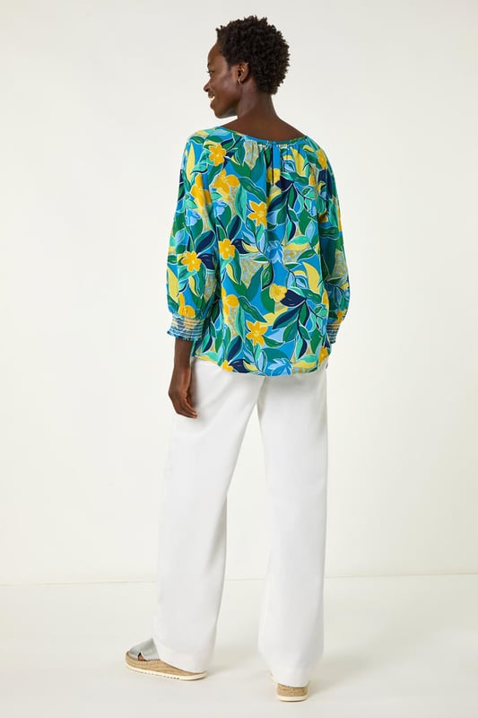 Leaf Print 3/4 Sleeve Top from Roman. Channel tropical vibes with this leaf print top, perfect for the Spring Summer season. The flattering square neckline and 3/4 length sleeves make this tee a must-have in your wardrobe. Crafted from a comfortable woven fabric, it showcases an all-over tropical leaf print for a fresh and stylish look. Dress it up with a denim jacket and jeggings for the ultimate casual outfit!