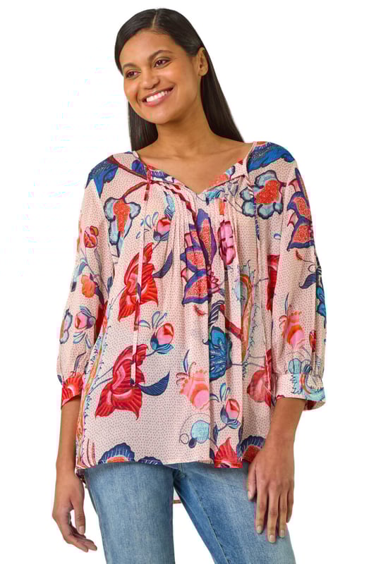 Floral Print Tie Front Top from Roman. Embrace the beauty of Spring/Summer in this delightful floral print top. Featuring an all-over floral print, this round neck top has a charming tie front detail and elegant 3/4 sleeves. Perfect for a casual day out, simply pair with jeans and sandals for an effortlessly chic look that exudes laid-back style!