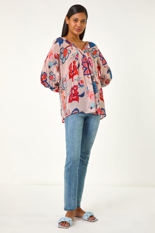 Floral Print Tie Front Top from Roman. Embrace the beauty of Spring/Summer in this delightful floral print top. Featuring an all-over floral print, this round neck top has a charming tie front detail and elegant 3/4 sleeves. Perfect for a casual day out, simply pair with jeans and sandals for an effortlessly chic look that exudes laid-back style!
