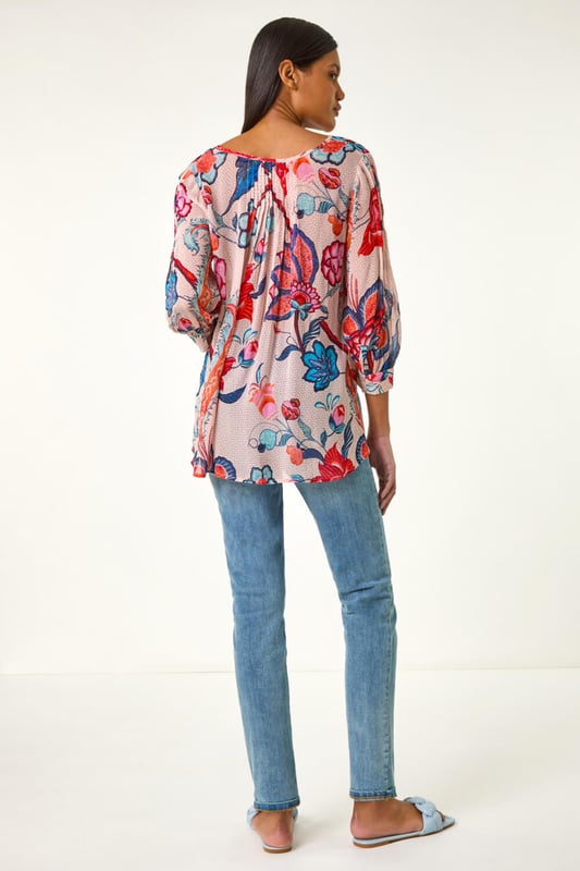 Floral Print Tie Front Top from Roman. Embrace the beauty of Spring/Summer in this delightful floral print top. Featuring an all-over floral print, this round neck top has a charming tie front detail and elegant 3/4 sleeves. Perfect for a casual day out, simply pair with jeans and sandals for an effortlessly chic look that exudes laid-back style!