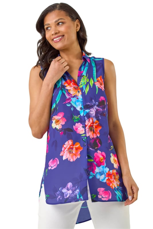Floral Leaf Print Longline Button Blouse from Roman. Step into the new season in style with this trendy sleeveless blouse featuring a smart shirt style collar. Crafted from a comfortable woven fabric, this top showcases a pretty floral and leaf print, taking your outfit to the next level. Designed in a flattering longline shape with intricate front button details, this top is perfect for a fashionable look this Spring Summer. Pair with a denim jacket and jeggings!