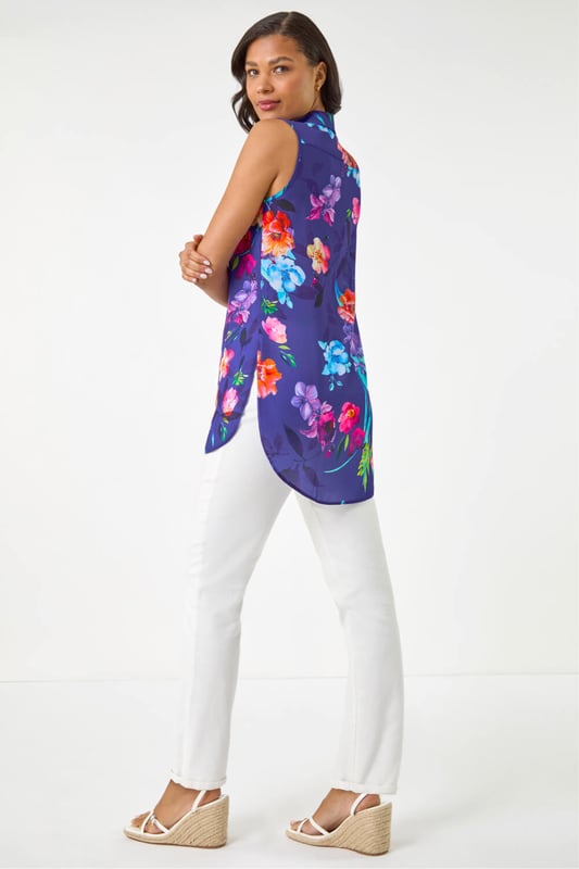 Floral Leaf Print Longline Button Blouse from Roman. Step into the new season in style with this trendy sleeveless blouse featuring a smart shirt style collar. Crafted from a comfortable woven fabric, this top showcases a pretty floral and leaf print, taking your outfit to the next level. Designed in a flattering longline shape with intricate front button details, this top is perfect for a fashionable look this Spring Summer. Pair with a denim jacket and jeggings!