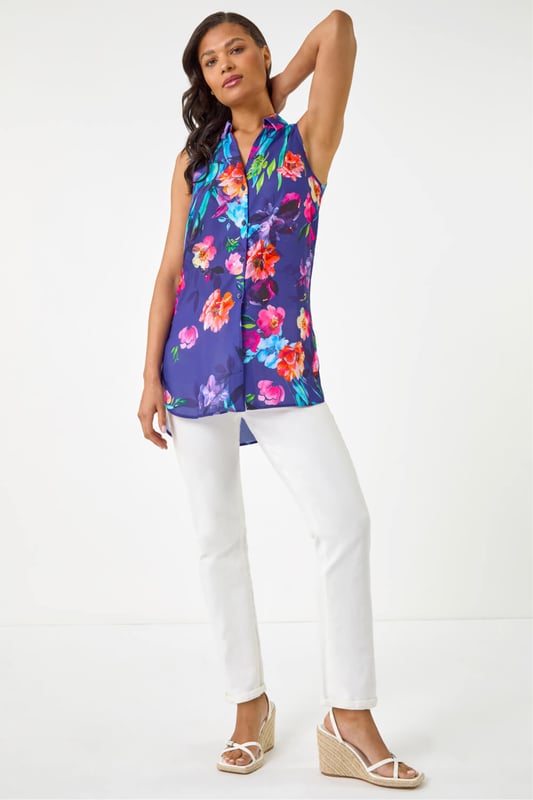 Floral Leaf Print Longline Button Blouse from Roman. Step into the new season in style with this trendy sleeveless blouse featuring a smart shirt style collar. Crafted from a comfortable woven fabric, this top showcases a pretty floral and leaf print, taking your outfit to the next level. Designed in a flattering longline shape with intricate front button details, this top is perfect for a fashionable look this Spring Summer. Pair with a denim jacket and jeggings!
