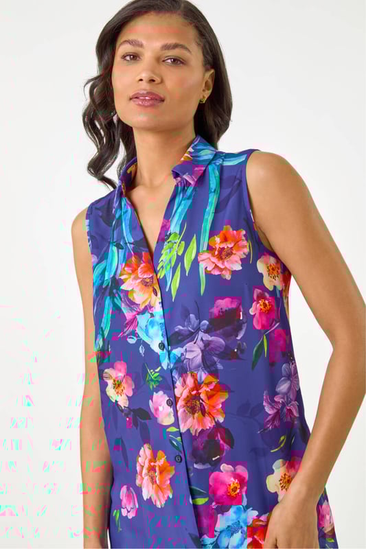 Floral Leaf Print Longline Button Blouse from Roman. Step into the new season in style with this trendy sleeveless blouse featuring a smart shirt style collar. Crafted from a comfortable woven fabric, this top showcases a pretty floral and leaf print, taking your outfit to the next level. Designed in a flattering longline shape with intricate front button details, this top is perfect for a fashionable look this Spring Summer. Pair with a denim jacket and jeggings!